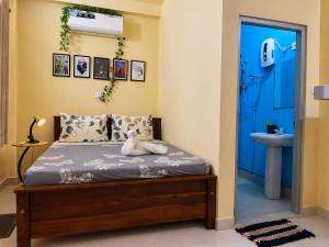 a bedroom with a bed and a blue door at Donald House Cabana Kandy in Kandy