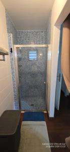 a shower with a glass door in a bathroom at Superbe Suite parentale Chez l'habitant avec SPA et petit déjeuner in Saint-Pierre