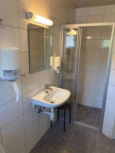 a bathroom with a sink and a shower at Family Cabins in Fjæra