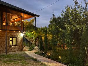 a stone house with a staircase and a patio at Harmony Guest House in Ijevan