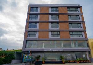 a tall building with a store in front of it at Hotel 5 Elements By Fidato Hotels in Akalkot +23 photos