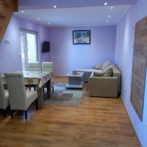 a living room with a table and a couch at Apartmani Aleksijević Zlatibor in Zlatibor