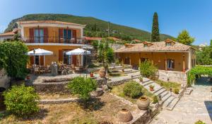 a house with a garden in front of it at Archontiko Maisonettes in Alykes