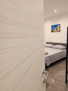 a door leading to a bedroom with a bed at I Due Moli 2'0 Vibo Marina in Vibo Valentia Marina