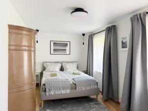 a bedroom with a bed and a large window at Liedagas in Kolka