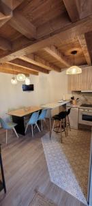 a kitchen and dining room with a table and chairs at A Bodega da Xesteira in Melón