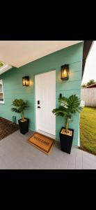a house with two palm trees in front of a door at The Arlington Hideaway in Jacksonville