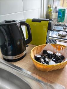 a basket of pots and spoons on a kitchen counter at Intime Poto House Suceava in Suceava