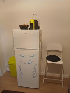 a refrigerator with a face drawn on it next to a chair at La Vinella in Lamezia Terme +6 photos
