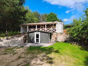 a house with a garage in front of it at Sodyba Valdo kubilas in Trakai