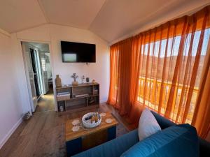 a living room with a blue couch and a tv at Malak Farma in Kakanj
