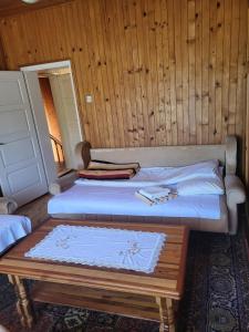 a bedroom with two beds and a wooden wall at Kod Marijanovića in Andrijevica