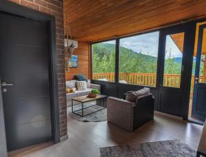 a living room with a view of a mountain at Malak Farma in Kakanj