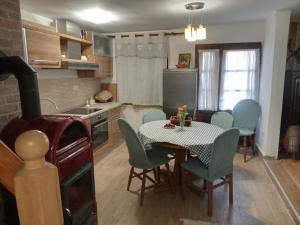 a kitchen with a table and chairs in a kitchen at Kuća za odmor Urša in Brod na Kupi