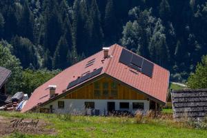 a house with a roof with solar panels on it at Wieserhof Sellrain in Sellrain