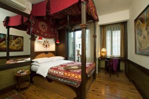a bedroom with a canopy bed in a room at Hotel Empress Zoe in Istanbul