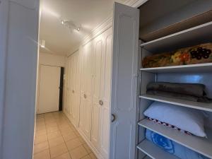 a walk in closet with white cabinets at Appartement spacieux in Argenteuil