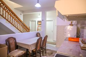 a kitchen and dining room with a table and chairs at Guesthouse Elsa in Ulcinj