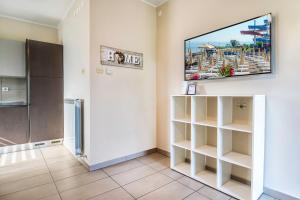 a living room with a flat screen tv on a wall at Prostorni in udobni apartmaji Izola SL - Spacious & Comfortable Apartments Izola SL in Izola