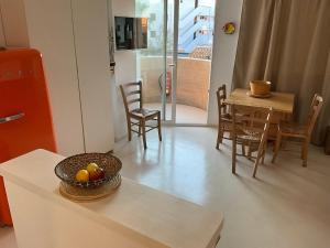 a living room with a table with a bowl of fruit on it at Es Pujols Vista Mare in Es Pujols