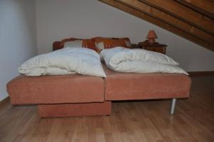 a bed with two pillows on top of it at Immeuble La Foret in Vex