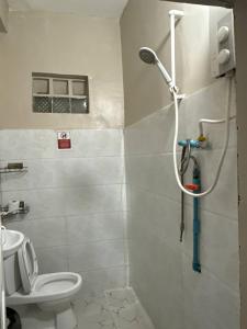 a bathroom with a shower with a toilet and a sink at Koh Rong Homestay in Kaôh Rŭng (3)