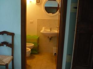 a bathroom with a sink and a toilet and a mirror at Agriturismo Biologico la Casa degli Gnomi in Ortezzano
