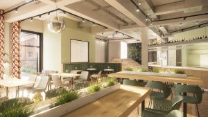 un ristorante con tavoli e sedie in una stanza di MEADOW Gronau by Hackmann a Gronau