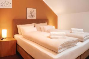 a bedroom with two beds with white sheets at Mountain Suite A10 - by FiS in Tauplitz