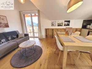a living room with a table and a couch at Mountain Suite A10 - by FiS in Tauplitz