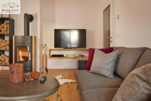 a living room with a couch and a fireplace at Mountain Suite A10 - by FiS in Tauplitz