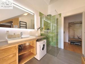 a bathroom with a sink and a washing machine at Mountain Suite A10 - by FiS in Tauplitz +42 photos