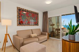 a living room with a couch and a tv at Callao Beach 6 in Arrieta