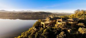 an aerial view of a house on the edge of a lake at Cloud 9 Luxury Eco Villa in Sedgefield