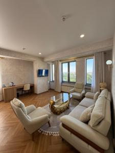 a living room with a couch and chairs and a table at Safia Plaza Hotel in Bukhara