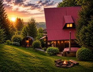 a house with a red roof and a fire pit at Chata pod lasem z balią i sauną in Myślenice