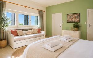 a bedroom with a large bed and a couch at Villa Coccodrilla in Toscolano Maderno