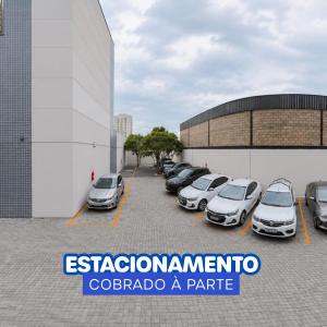 a group of cars parked in a parking lot at Hotel Dan Inn Uberlandia By Nacional Inn in Uberlândia