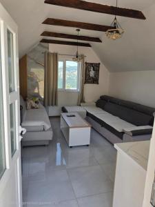a living room with a couch and a table at Jezerina in Šavnik