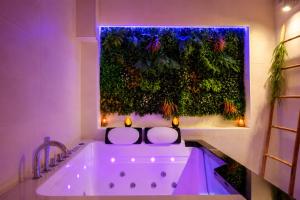 a bath tub in a bathroom with a green wall at Beau gîte avec jacuzzi in Barr +44 photos
