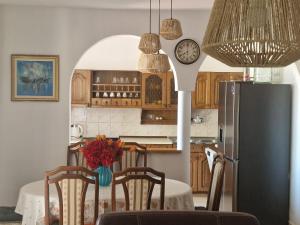 a kitchen with a table and a refrigerator at Casa Julia in Herceg-Novi