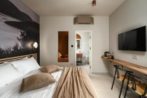 a bedroom with a bed and a flat screen tv at Fančita Rooms B&B in Vrsar