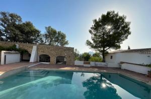 an outdoor swimming pool in front of a house at Casita Molivent in Parcent