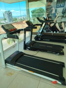 a gym with three tread machines and a window at Studio 404 Premium Flat - Juazeiro do Norte - Cariri in Juazeiro do Norte