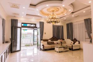 a large living room with a chandelier and a couch at Hoanglee Villa in Da Thanh