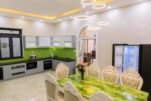 a kitchen and dining room with a table and chairs at Hoanglee Villa in Da Thanh