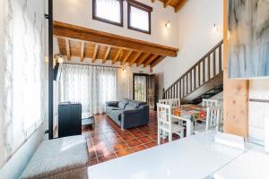 a living room with a couch and a table at La Dehesa de Santa Ursula Completo in Espeja de San Marcelino