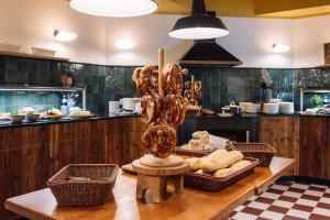 a kitchen with a table with some donuts on it at HENRI Hotel Garmisch-Partenkirchen in Garmisch-Partenkirchen