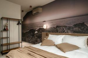 a bedroom with a bed with a painting on the wall at Fančita Rooms B&B in Vrsar