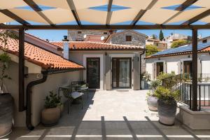 a patio with awning and a table and chairs at Fančita Rooms B&B in Vrsar